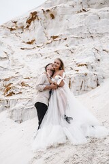 Fototapeta premium Beautiful wedding couple bride and groom at wedding day outdoors at ocean beach. Happy marriage couple o
