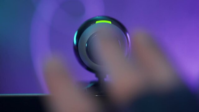 Webcam recoding and filming video - hand waves in front to check if it works. Video chat camera on computer screen begins filming. Privacy or spying illegal activity hacking into someone's computer
