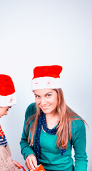 Fototapeta premium Young mother with daughter at home for Christmas. Happy family in holiday season