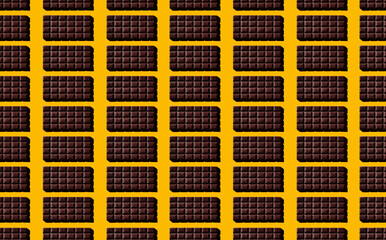 Pattern of chocolate bars on yellow pastel background