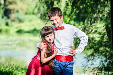 Cute boy and girl, brother and sister, in traditional Ukrainian embroidered clothes.