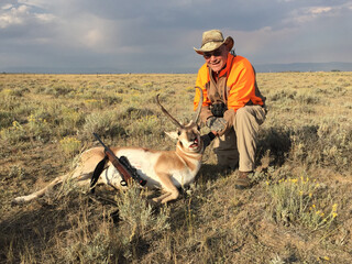 A hunter with a trophy antelope 