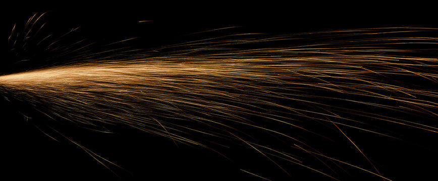 red fast-flying sparks from angle grinders on black background