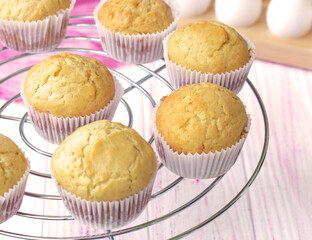 Selective focus. classic homemade muffins are cooled on a wire rack to cool. Fresh vanilla cupcakes close up. Vanilla baked goods. High quality photo