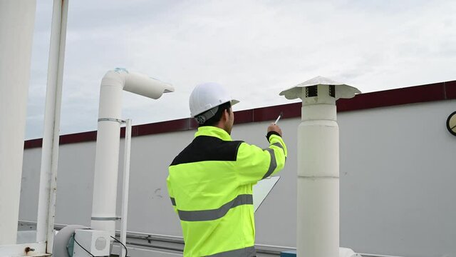 Air conditioning technicians repair and maintain condensing units outside the building, engineers inspect the operation of ventilation fans.