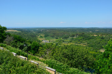 Fototapeta na wymiar The view of the surrounding summer landscape from the historic medieval hill village of Buje in Istria, Croatia 