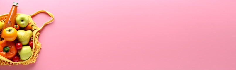 Grocery bag with fresh products on color background with space for text
