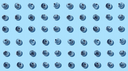 blue background with ripe blueberries
