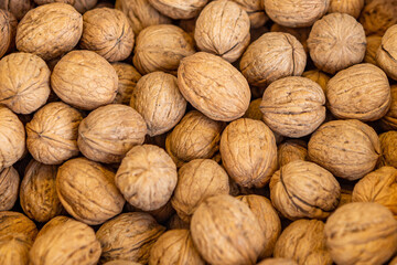 Healthy food-Inshell walnuts are sold at the food market. Natural walnut, background, pattern, texture. A fresh crop of nuts. The concept of healthy eating.