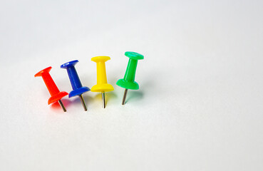 four different colorful push pins isolated on white background