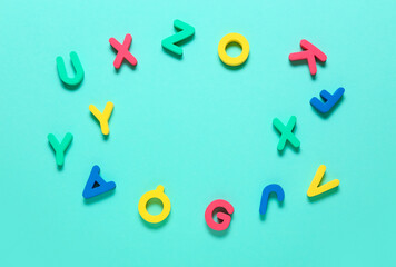 Frame made of letters on color background