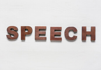 Word SPEECH on white wooden background