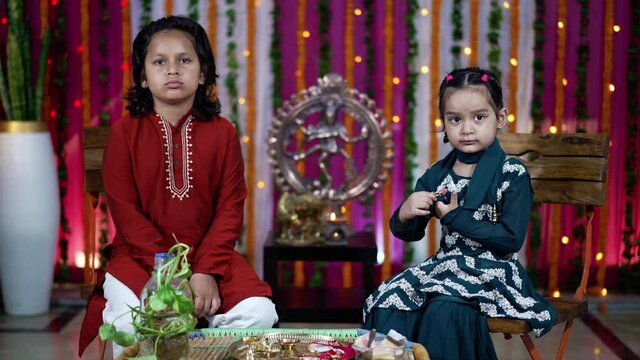 Indian children wearing ethnic Indian dress during Raksha Bandhan, a festival to celebrate the bond between brother-sister. Decoration in Indian houses.