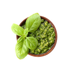 Bowl with fresh pesto sauce and basil leaves on white background