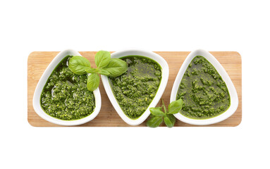 Bowls with fresh pesto sauce on white background
