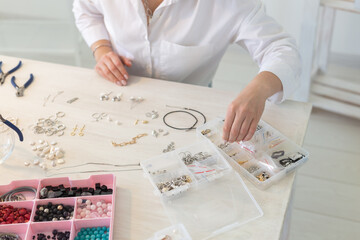 Professional jewelry designer making handmade jewelry in studio workshop close up. Fashion, creativity and handmade concept