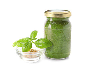 Jar with fresh pesto sauce and ingredients on white background