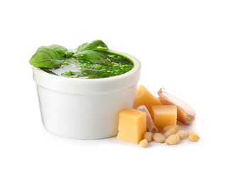 Bowl with fresh pesto sauce and ingredients on white background
