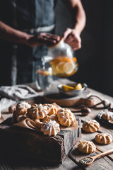 Man pours Hot tea with slices of fresh grapefruit on wooden tablet. Healthy drink, Eco, vegan.