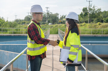 Environmental engineers work at wastewater treatment plants,Water supply engineering working at Water recycling plant for reuse,Technicians and engineers discuss work together.