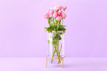 Vase with beautiful peony roses on color background