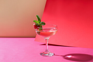 Glass of tasty cosmopolitan cocktail on color background