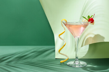 Glass of tasty cosmopolitan cocktail on color background