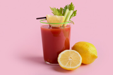 Glass of bloody mary cocktail and lemons on color background