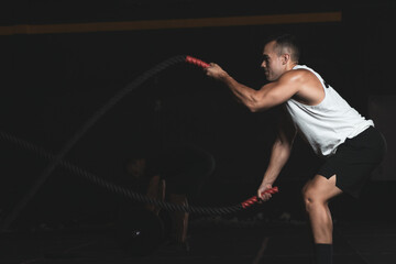 Fototapeta na wymiar a Turkish boy moving ropes inside a gym.