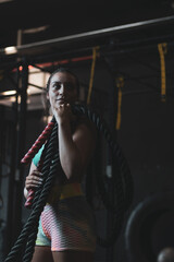 Fototapeta na wymiar a Colombian girl posing with ropes in a gym.