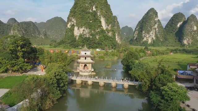 Beautiful aerial view of the landscape, the old bridge, the karst mountains and the river, in the village of Ohkakuhnem, in Guizhou province, China.