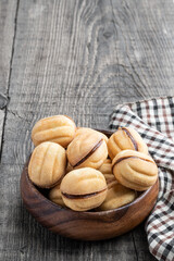 traditional russian walnut tea-cakes in wooden bowl on rustic table