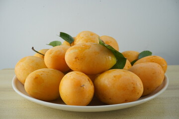 Mayongchid on a plate on Wood Table and White wall with clipping path.