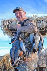 A hunter with a strap of waterfowl 