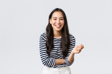 Lifestyle, people emotions and casual concept. Carefree happy outgoing asian woman having fun talking to people, laughing and smiling upbeat, standing white background cheerful - Powered by Adobe