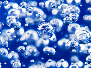 Abstract air bubbles in a glass sphere on a blue background