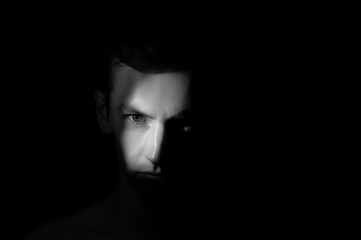 dramatic portrait of a man on black background