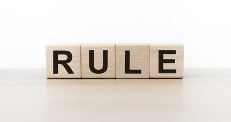 Rule word on wooden cubes on light background