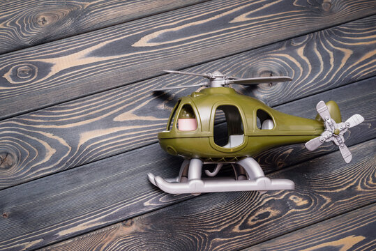 Children helicopter toy on the wooden floor background with copy space.