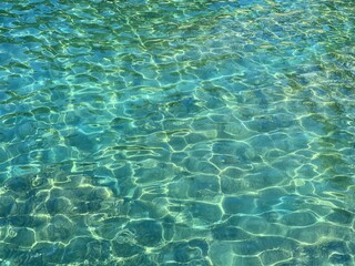 Transparent green sea water surface in tropical paradise lagoon. Beautiful summer seascape.  Sea smooth stones. Calm ocean water. Zen. Relax. Nature. 