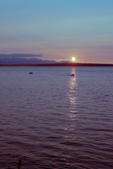 pastel summer sunset over the sea ocean puget sound with boats pacific northwest seattle
