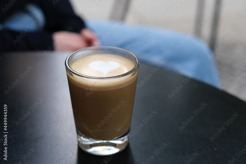 Wall mural Glass of coffee with latte art