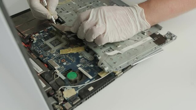 The master repairs the laptop. Laptop repair. Computer repair service 
