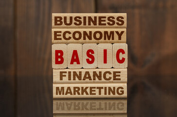 Wooden blocks with the text - Business, Economy, Finance, Marketing and BASIC