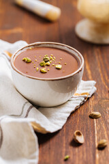 Chocolate pudding with pistachio crumbs on top