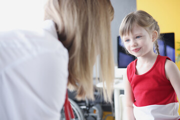 Little beautiful girl communicates with woman doctor