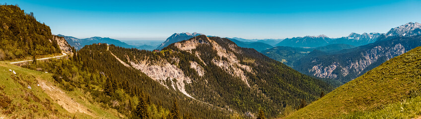 Naklejka na ściany i meble High resolution stitched panorama of a beautiful alpine summer view with the Kreuzeckbahn at the famous Alpspitze summit near Garmisch Partenkirchen, Bavaria, Germany