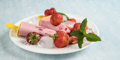 Close-up of homemade vegan ice cream on coconut milk with strawberries. Healthy summer desserts