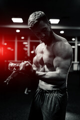 Fototapeta na wymiar Athlete strong sporty bodybuilder. Handsome muscular man posing in the gym.