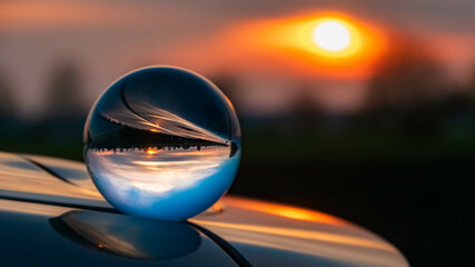 Obraz premium Crystal ball landscape shot with reflections on a car roof at Ganacker, Bavaria, Germany